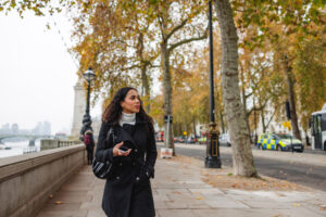 Hispanic business woman, walking along London street